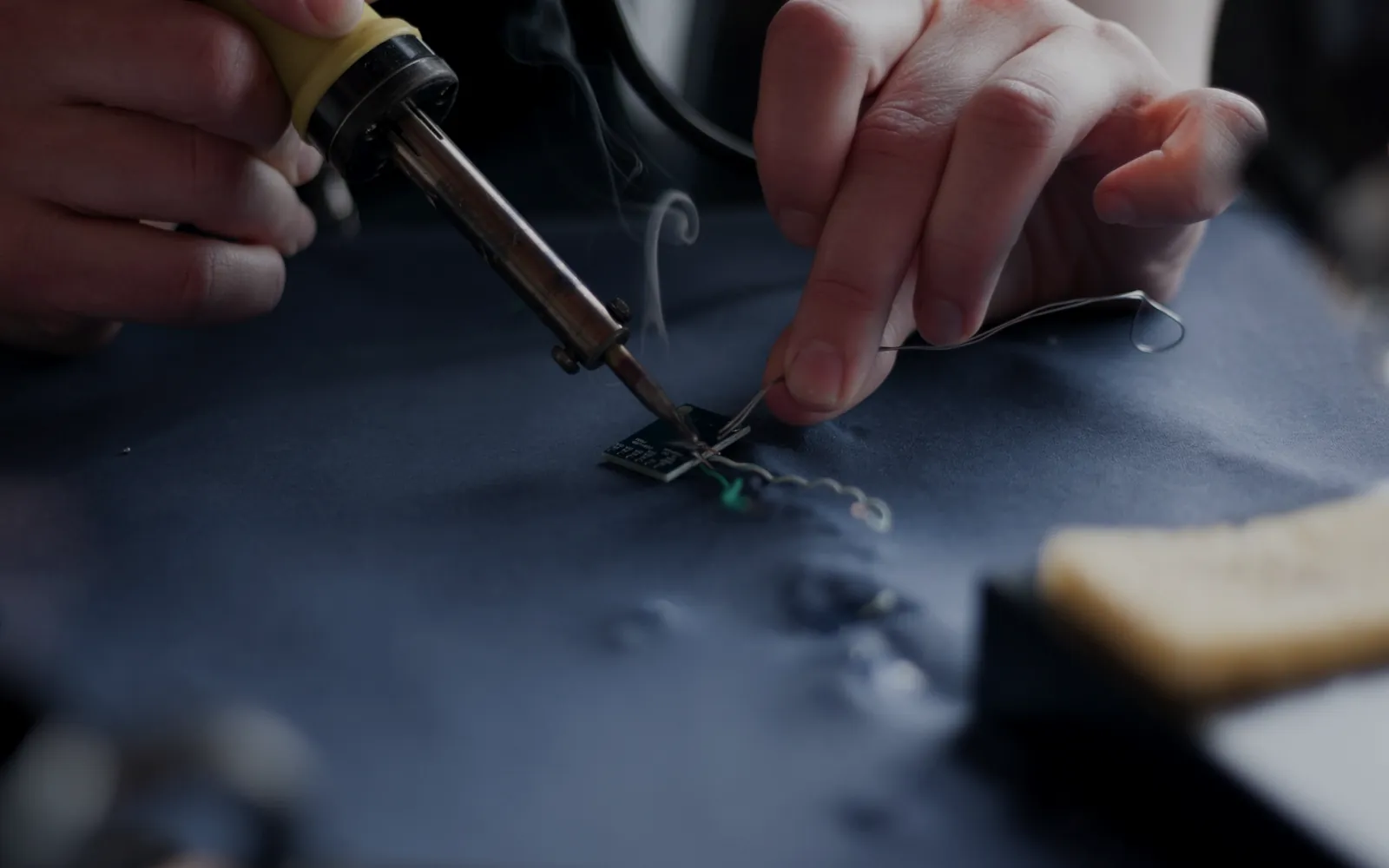 Hands soldering a circuit board