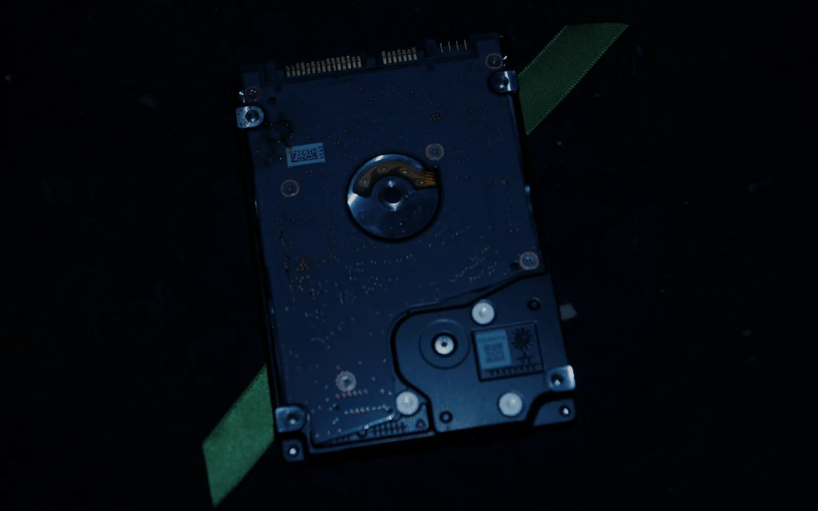 Bare hard-drive platter assembly on a black table