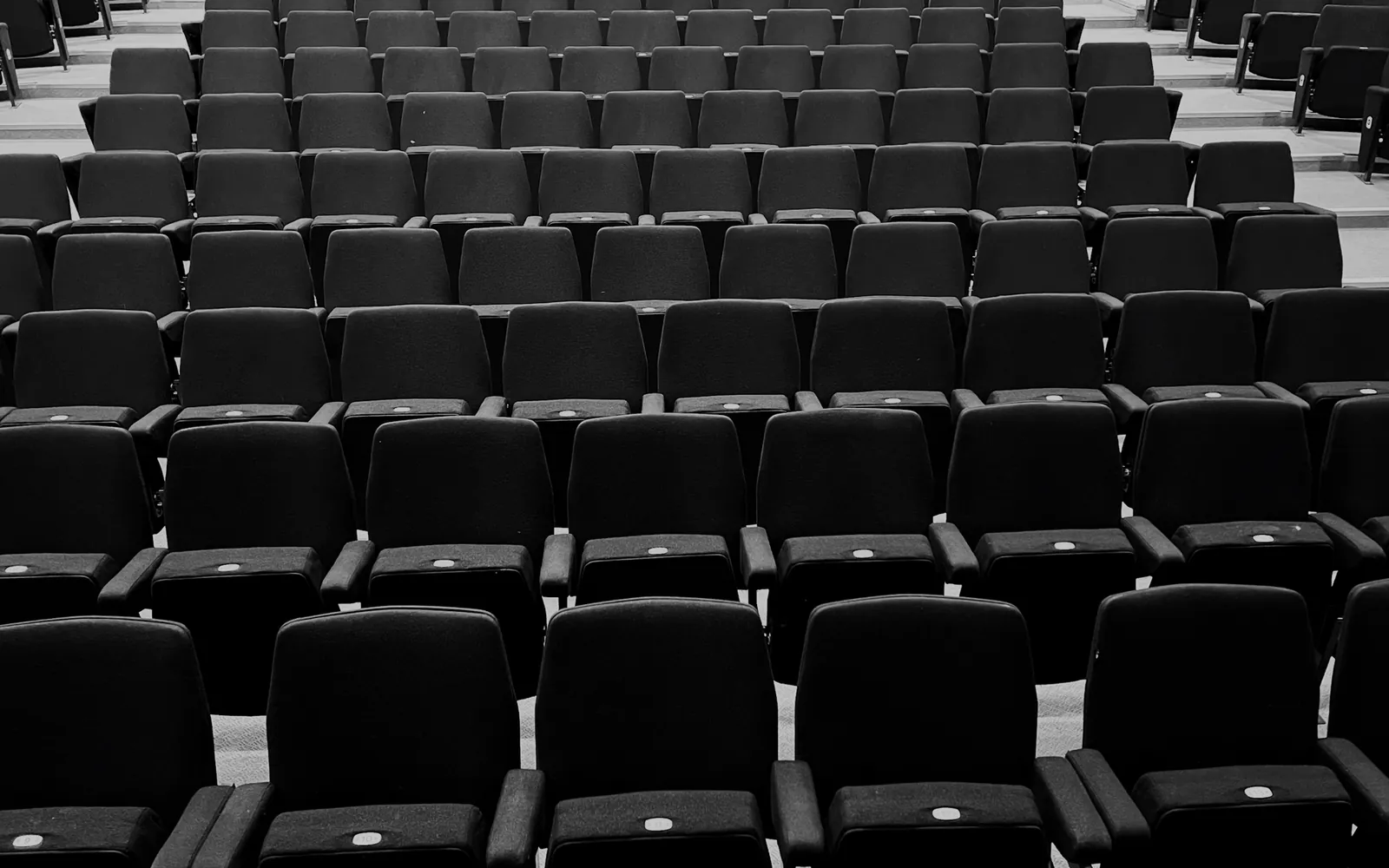 Rows of empty dark auditorium seats