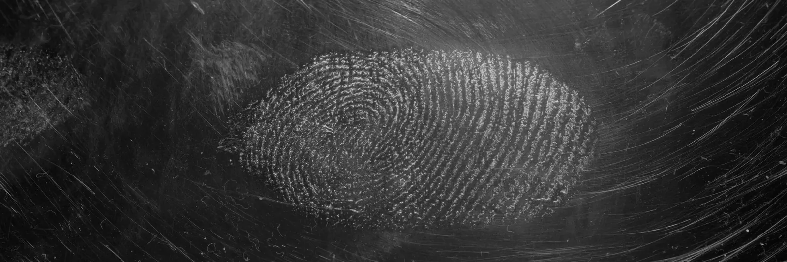 Fingerprint on a dark textured surface