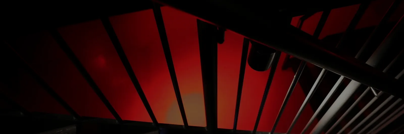 Red-lit panels above a stone staircase